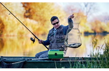 Image of Man catching fish with a fishing net