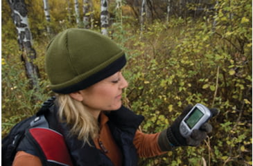 Image of Woman Using GPS Device in the Woods