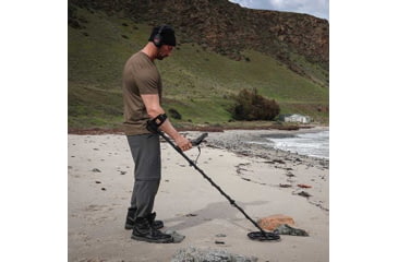 Image of Man Using Minelab Equinox 900 Metal Detector on Beach