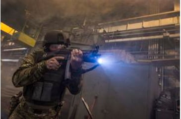Image of Tactical Operator Aiming MP5 With Weapon Mounted Light