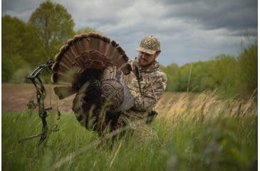 Image of Bowhunter Examining Turkey