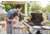 Father teaching son to grill