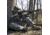 Turkey hunter taking aim with shotgun.