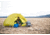 Man and a dog camping in a yellow Marmot tent