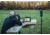 Man Practicing Long-Range Shooting and Using a Target Camera