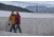 Man and Woman Walking and Wearing Winter Jackets