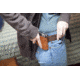 Woman Adjusting Concealed Holster