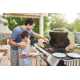 Father teaching son to grill