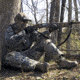 Turkey hunter taking aim with shotgun.