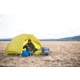 Man and a dog camping in a yellow Marmot tent