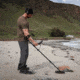 Man Using Minelab Equinox 900 Metal Detector on Beach