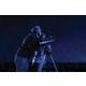 Two People Using a Telescope at Night
