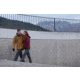 Man and Woman Walking and Wearing Winter Jackets