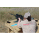 Woman shooting a rifle at a long-distance shooting range