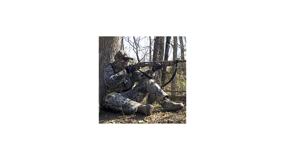 Turkey hunter taking aim with shotgun.