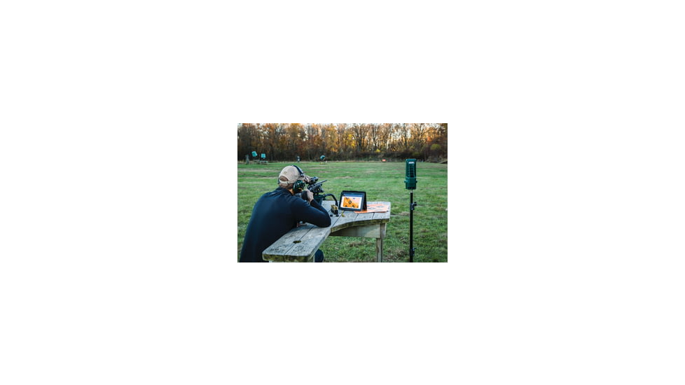 Man Practicing Long-Range Shooting and Using a Target Camera