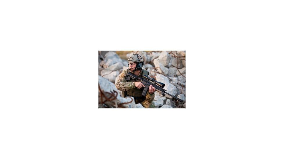 Man in Military Gear with a Suppressor on his Rifle