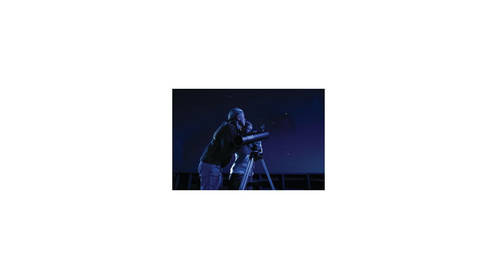 Two People Using a Telescope at Night