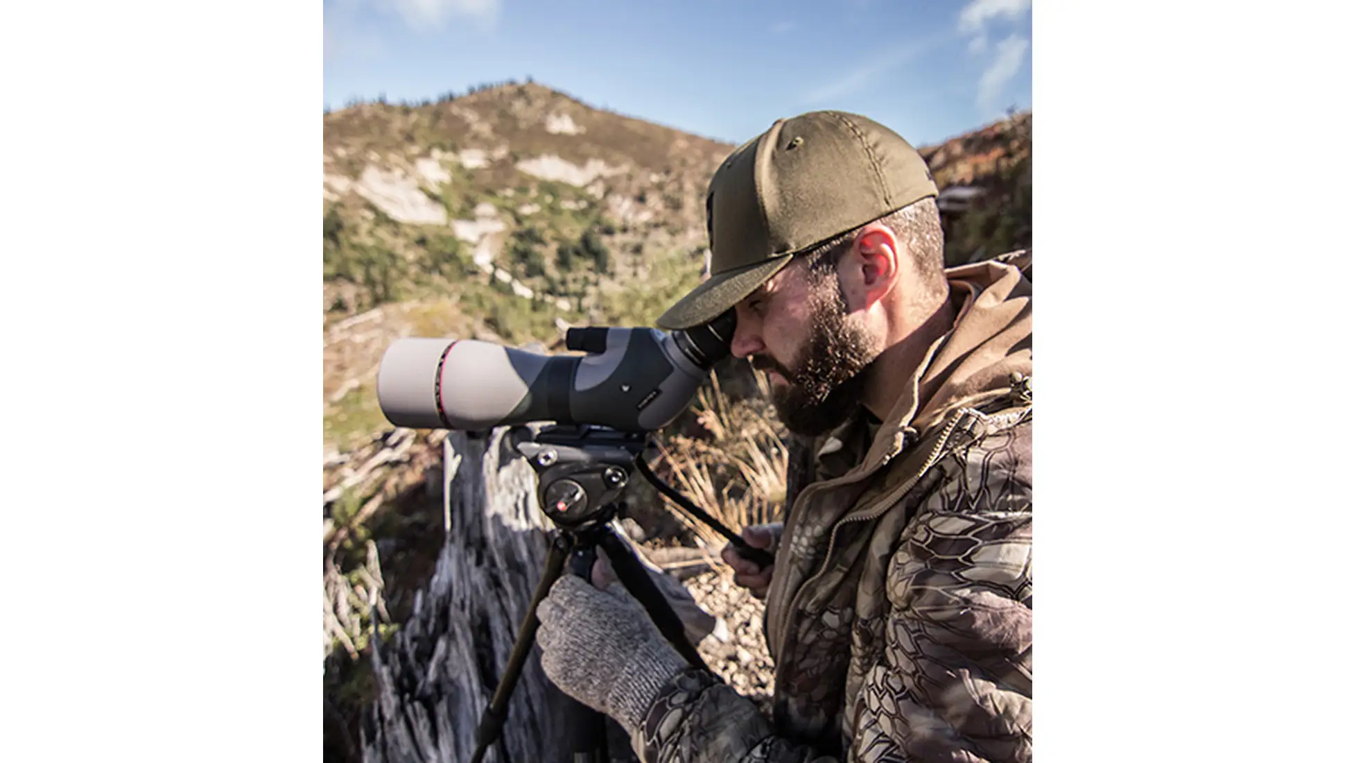 Man in Kryptek Camo Hunting Gear Using a Spotting Scope
