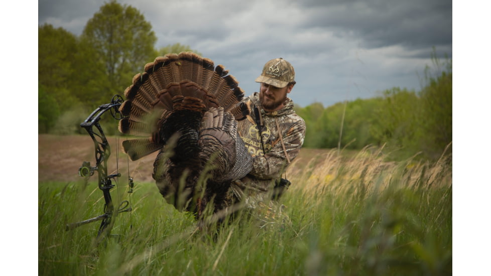 Bowhunter Examining Turkey