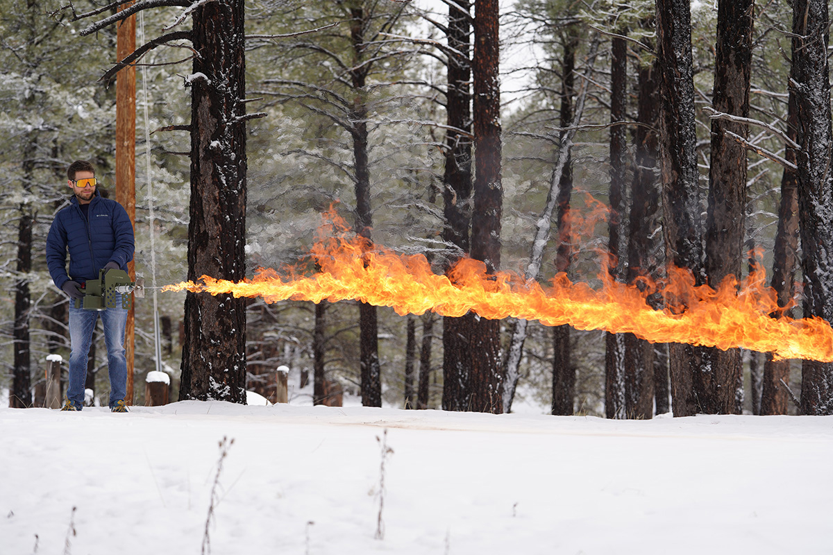 Man Using Exothermic Pulsefire LRT Flamethrower on Snow